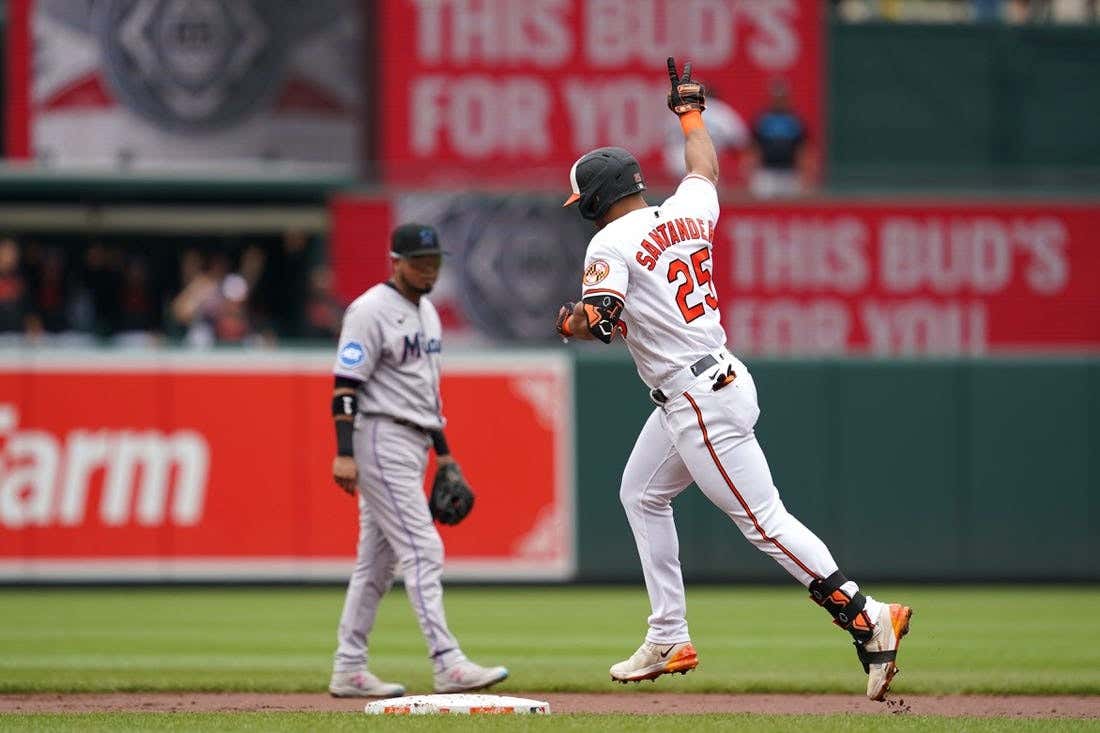 Jul 16, 2023; Baltimore, MD, USA; Baltimore Orioles outfielder Anthony Santander (25) hits two runs in the first inning against the Miami Marlins at Oriole Park at Camden Yards After a home run, walk around the bases.